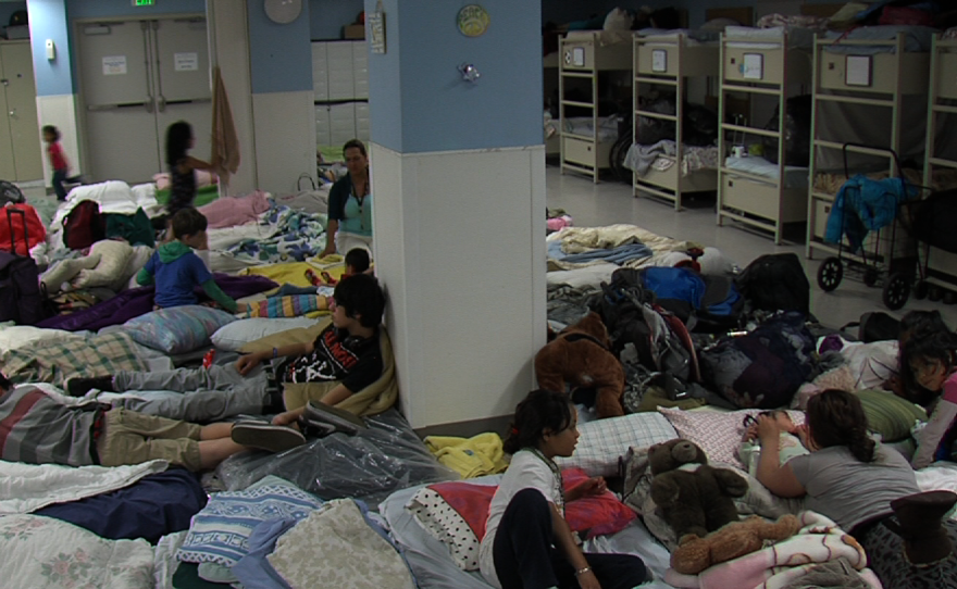 Homeless mothers and their children lay on blanket-covered mattresses at the San Diego Rescue Mission's Emergency Shelter, April 2013.