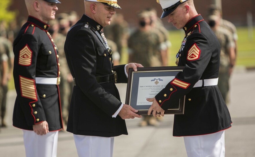Staff Sgt. Nick Jones (right) is awarded the Navy Cross by the commandant of the Marine Corps, Gen. David Berger, on Aug. 26.