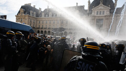 Riot police use a water cannon as they face students during a protest against under-resourced schools, in Rennes, western France, Tuesday.
