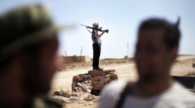 Libyan rebels gather at the front line on the eastern ridge of the Nafusah Mountains in Western Libya on Sunday.