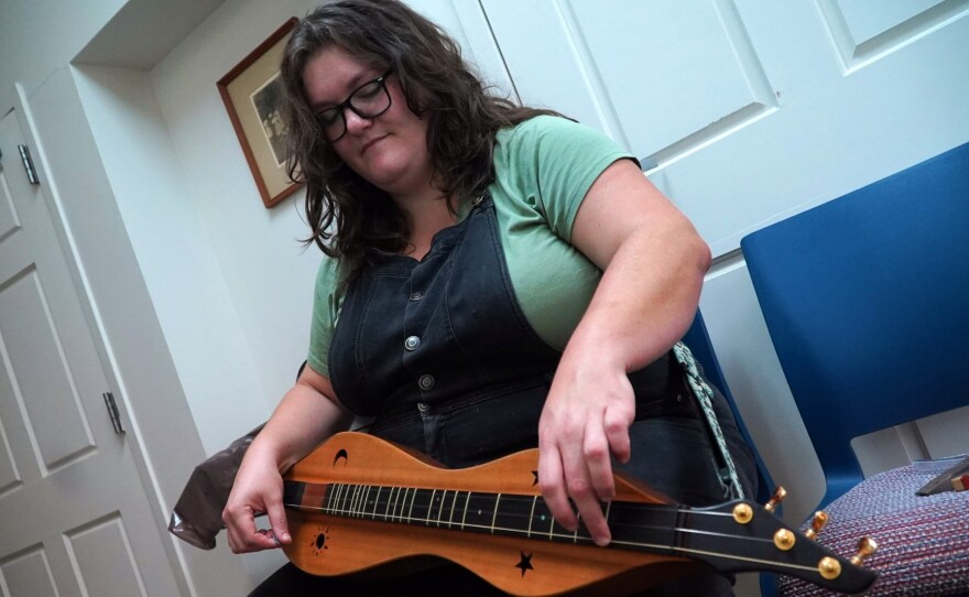 Sarah Kate Morgan, a director at Hindman Settlement School in Knott County, with her mountain dulcimer. After the floods, Morgan's role shifted from education to coordinating relief operations.