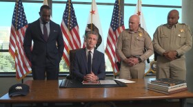 Gov. Gavin Newsom, flanked by California Highway Patrol officers, announcing CHP