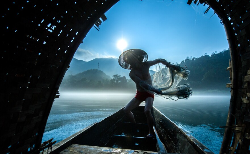 Second place: Fishermen in China set out early in the morning with their nets.