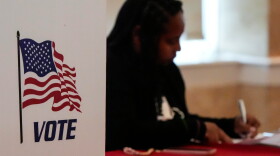 A Fulton County, Ga. staff member works as people vote in a runoff election in Atlanta on June 16, 2026.