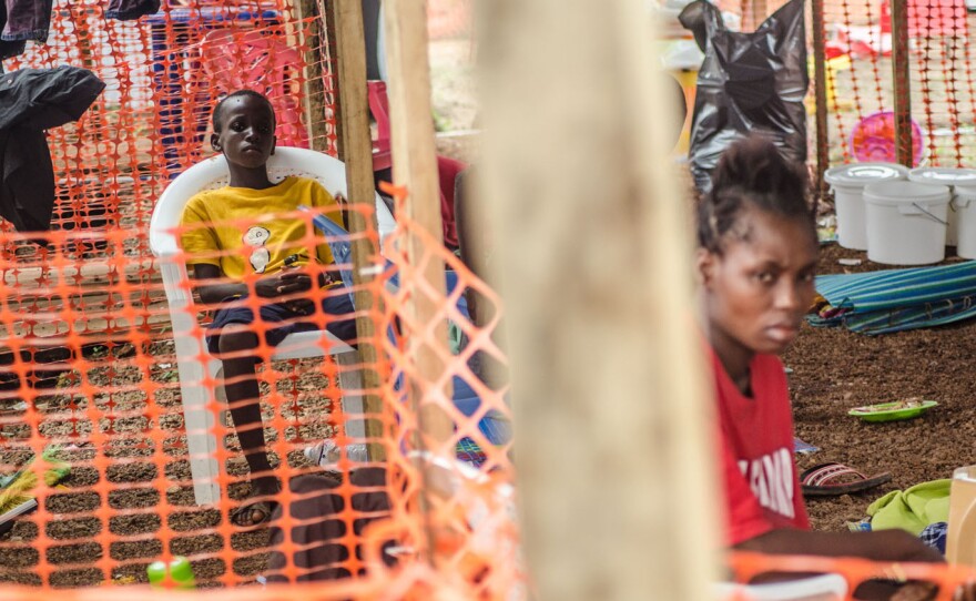 Two young patients rest at an Ebola isolation area run by Doctors Without Borders in Kailahun, Sierra Leone.