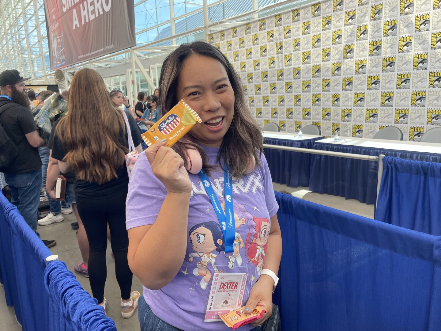 Annabelle Fletcher, a bookseller at Temecula's new romance bookstore, In Bloom Bookery, poses with her Comic-Con survival snacks on Thursday, July 24, 2025.