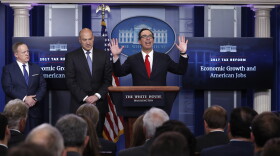 Treasury Secretary Steven Mnuchin, center, joined by National Economic Director Gary Cohn, center, and White House press secretary Sean Spicer speaks in the briefing room of the White House in Washington, Wednesday, April 26, 2017.