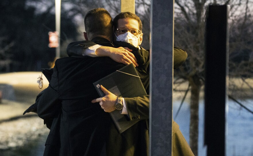 Congregation Beth Israel Rabbi Charlie Cytron-Walker, facing the camera, hugs a man after a healing service on Jan. 17, two days after he and three others were taken hostage at his Colleyville, Texas, synagogue.