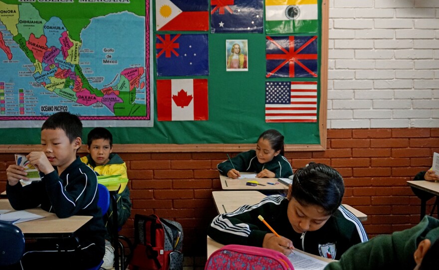 Students engage in a class project at the Escuela 20 Noviembre school in Tijuana, Mexico.