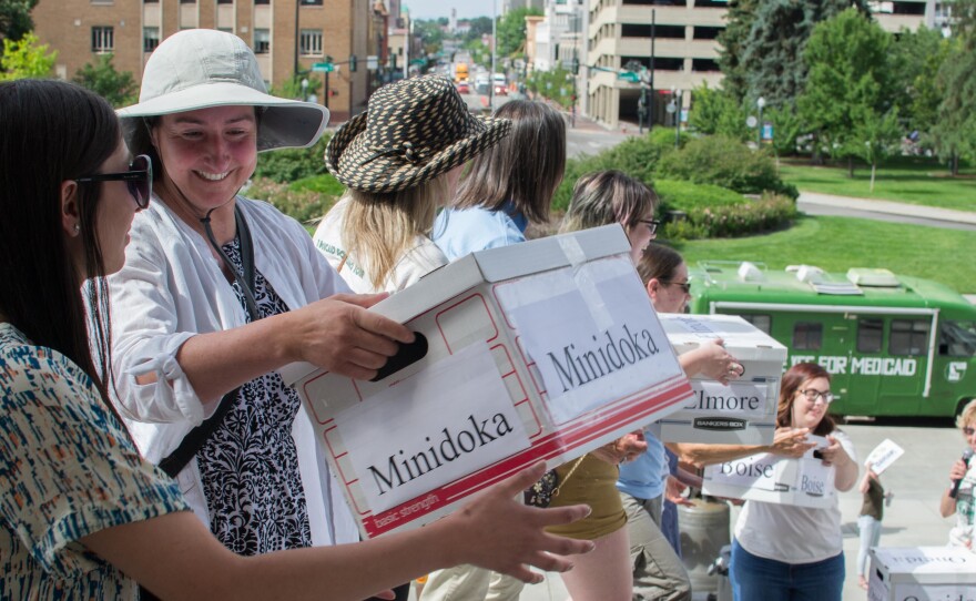 Volunteers pass boxes of signatures to qualify a 2018 ballot measure to expand Medicaid in Idaho. The coronavirus outbreak has halted other ballot initiatives in Idaho and other states.