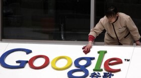 A worker cleans the logo at the Google China headquarters Monday in Beijing.