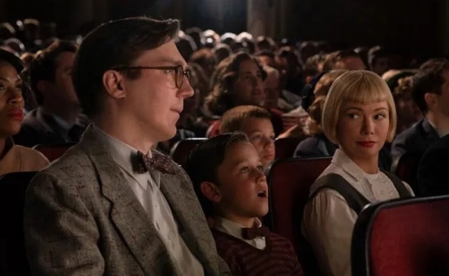 Young Sammy (Mateo Zoryon Francis-DeFord) experiences the magic of the movies with his parents (Paul Dano and Michelle Williams) in <em>The Fabelmans</em>.