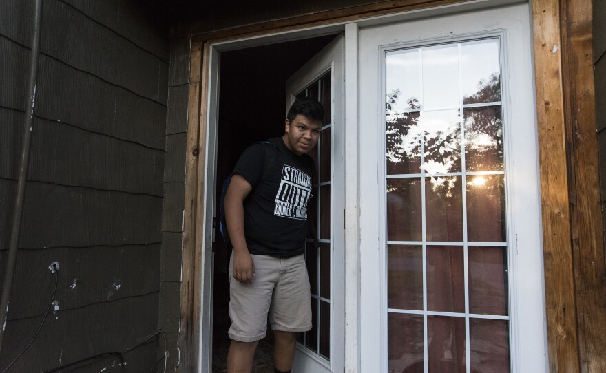 Jose pulls the door closed as the last one out his Tulsa, Okla., home. Jose and his family leave the house around 7:30 a.m. each weekday in order to get everyone to school on time.