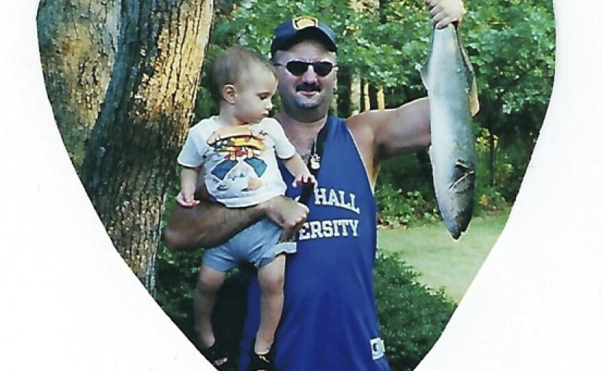 Alfonse Niedermeyer holds his son A.J. after catching a fish. Niedermeyer was a Port Authority police officer who rushed to the World Trade Center to help with rescues. He died in the south tower.