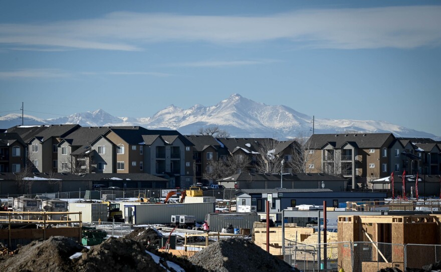 A development takes shape in January in Thornton, Colo., with the Rocky Mountains in the distance.