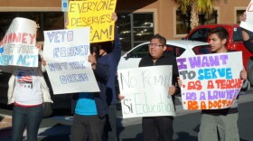 Latinos protest Mitt Romney's opposition to the Dream Act, outside his campaign headquarters in Las Vegas on Feb 2.