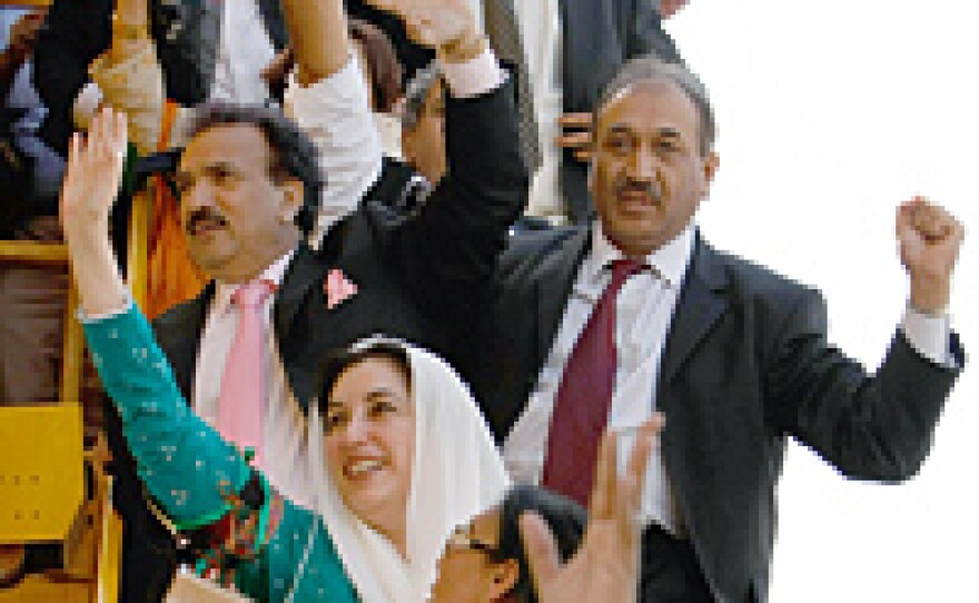 Former Pakistani Prime Minister Benazir Bhutto waves to followers on arrival in Karachi, Pakistan.