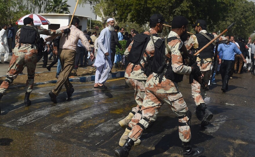 Pakistani paramilitary soldiers baton charge employees of Pakistan International Airlines during a protest near Karachi International Airport on Feb. 2. Two demonstrators were shot dead and several wounded at Karachi's airport when clashes broke out between security forces and staff from the national airline protesting privatization plans.