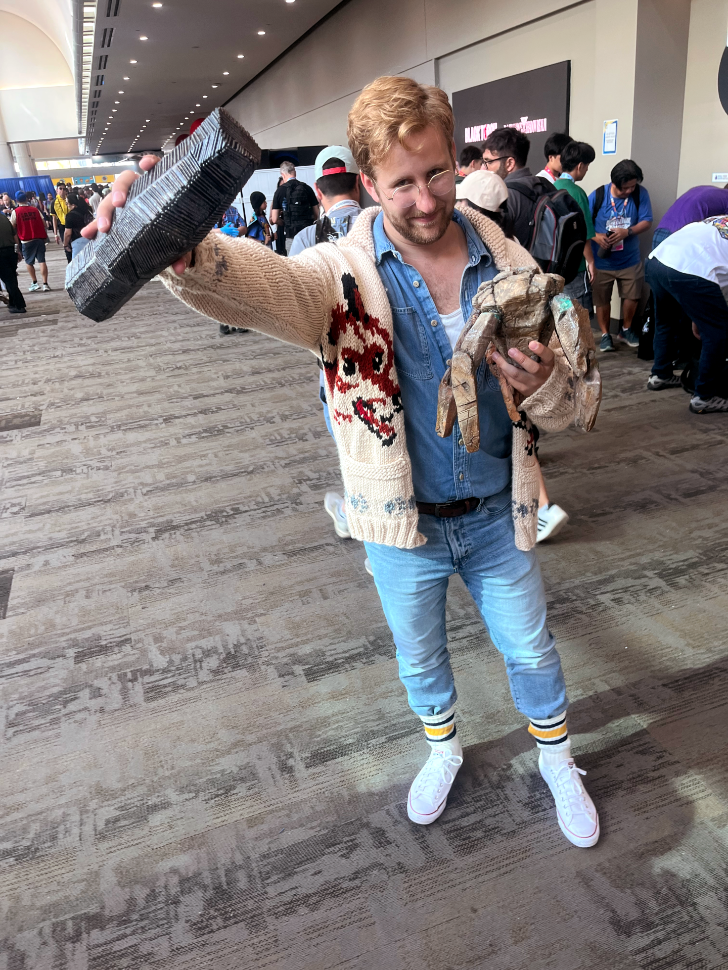 A cosplayer dressed as Ryland Grace from "Project Hail Mary" holds a replica Xenonite container and a model of Rocky, the five-legged alien, at Comic-Con on July 25, 2026.