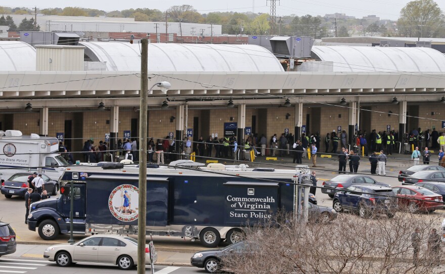 Police and rescue officials mingle with bus patrons outside the Greyhound Bus Station on Thursday in Richmond.