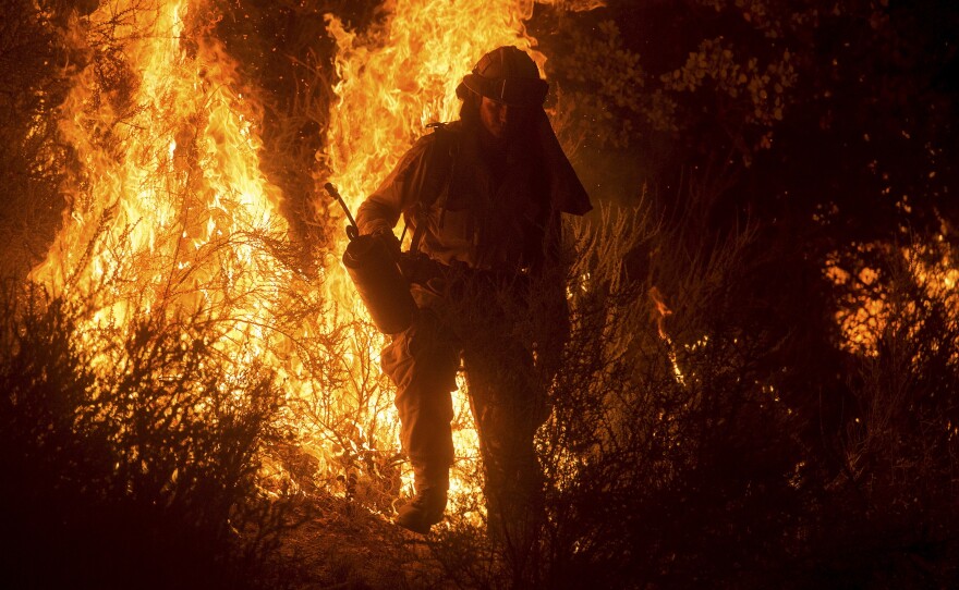 A firefighter lights a backfire while battling the Butte fire near San Andreas, California, on Saturday.