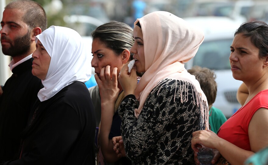 Syrian citizens line up to apply for visas outside the German embassy in Beirut. Lebanon hosts more than 1 million Syrian refugees.