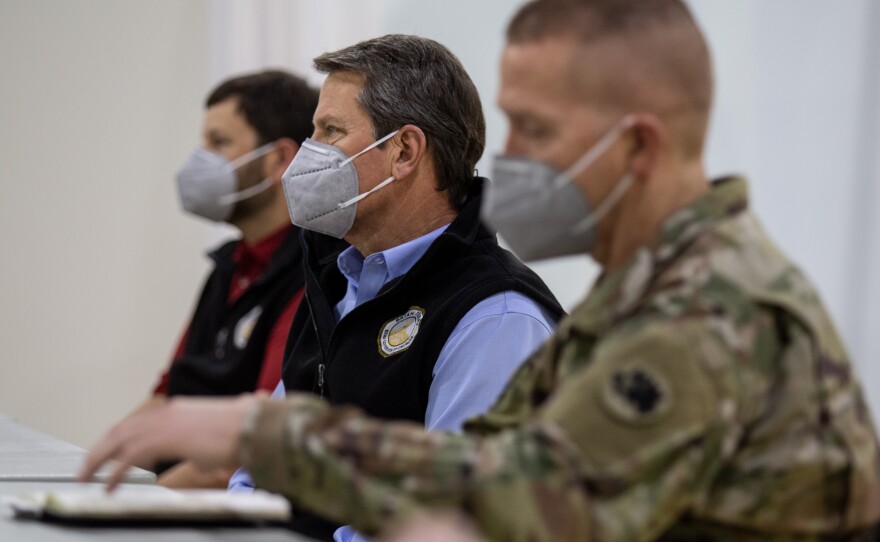 Georgia Gov. Brian Kemp (center) tours a temporary hospital in Atlanta last week. On Monday, he announced the first steps to reopen the state's economy, beginning on Friday.