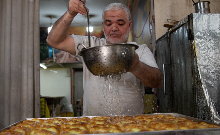 Rafe' Rummaneh prepares sweets at his bakery, April 9.
