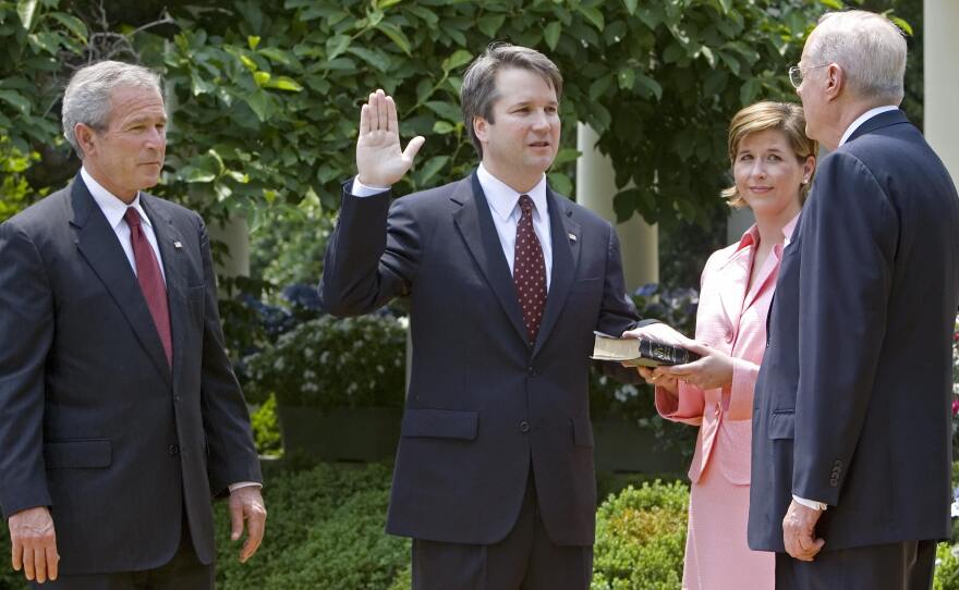 Brett Kavanaugh is sworn in as a federal judge by Supreme Court Justice Anthony Kennedy in 2006. President George W. Bush looks on. Kavanaugh is Trump's pick to replace Kennedy on the Supreme Court.