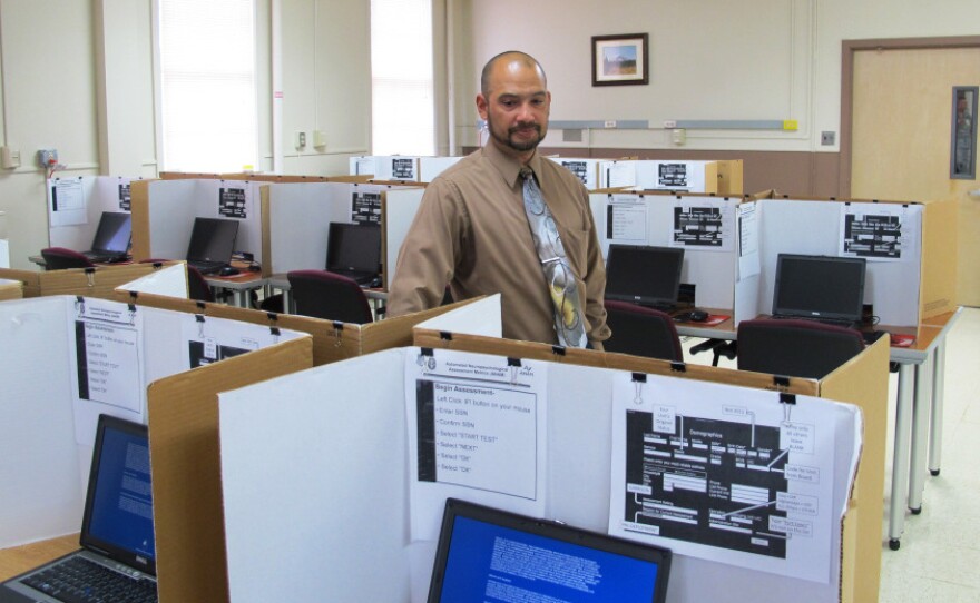 Felix Rios, a contractor with the Office of the Surgeon General, helps administer the ANAM test at Ft. Lewis, in Washington state. 
