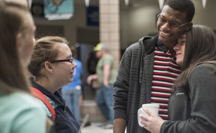 Gordon gets a hug from schoolmate Realyn Jeffcoat at North Middle/High.