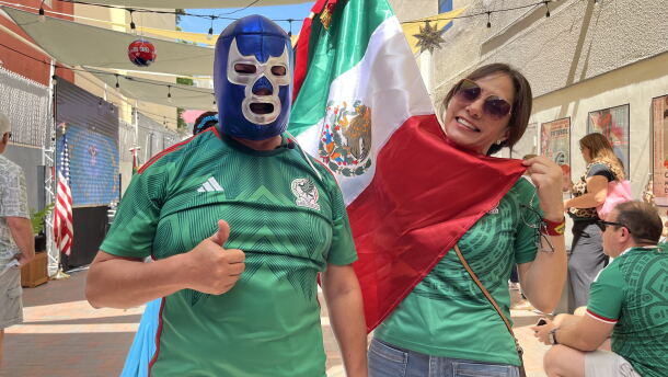 Jaime and Yolanda Guerrero dress in Mexico soccer kits, while donning a luchador mask and holding the Mexican flag, June 11, 2026.