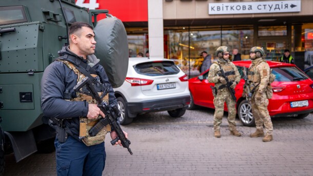 Police officers are seen at the site where a gunman killed at least six people in the streets before being shot dead by police, in Kyiv, Ukraine, Saturday, April 18, 2026.