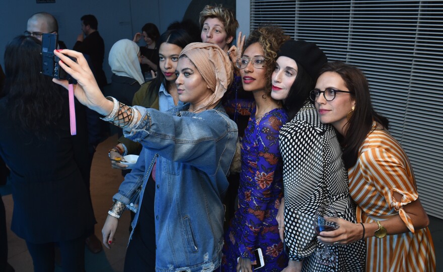 Amani Al-Khatahtbeh (center, holding camera), founder of MuslimGirl, and Elaine Welteroth (center, in glasses), former editor-in-chief of <em>Teen Vogue</em>, join a group selfie at National Geographic's premiere screening of <em>America Inside out with Katie Couric</em> in April in New York City.