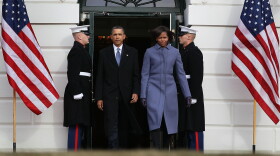 U.S. President Barack Obama and first lady Michele Obama walk up to participate in a moment of silence to honor those killed and wounded during a shooting in Tucson, Arizona on January 10, 2011 in Washington, DC. 