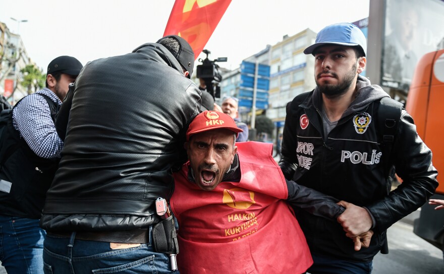 Turkish riot police clash with protesters as they attempt to defy a ban and march on Taksim Square to celebrate May Day in Istanbul.