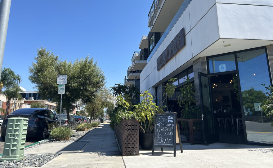 A coffee shop sits on a corner below apartments in the North Park neighborhood of San Diego.