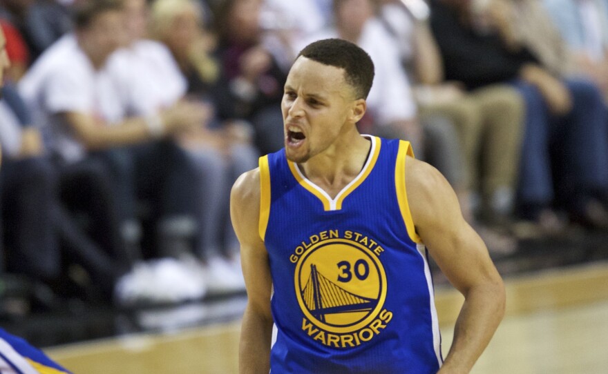 Golden State Warriors guard Stephen Curry reacts after scoring in the second half of the Warriors' Game 4 win over the Portland Trail Blazers on Monday night.