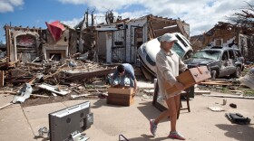 In the aftermath of a severe tornado, Kelly Giddens (R) helps University of Alabama law student Daniel Hinton remove belongings from his destroyed home in the Cedar Crest neighborhood on April 28, 2011 in Tuscaloosa, Alabama. 