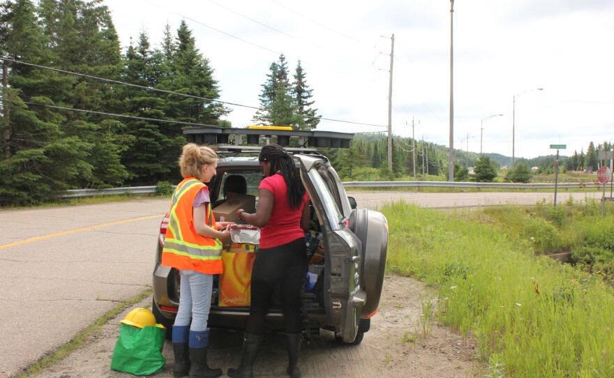 Environmental students Jaynina Deku and Valérie Bolduc review equipment in their Concordia University research vehicle.