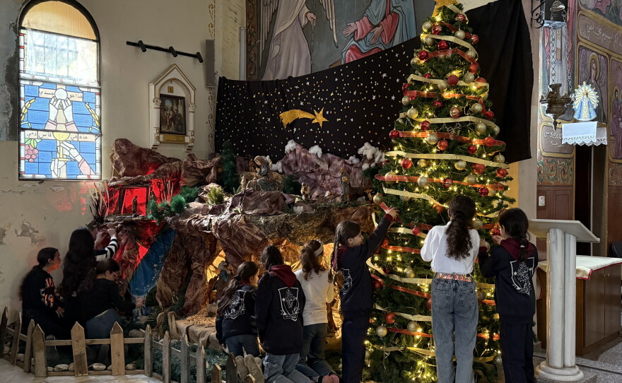 On Dec. 17, 2025, Palestinian Christian children decorate a Christmas tree inside the Holy Family Church in Gaza City for the first time since the beginning of the war.
