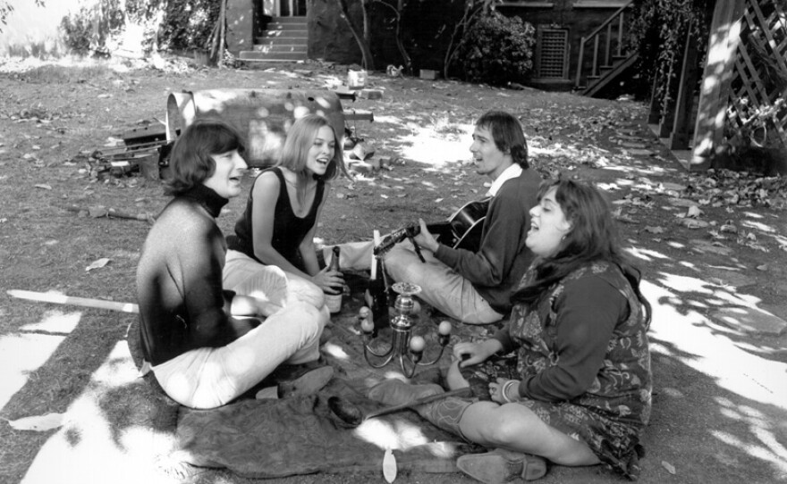 Denny Doherty, Michelle Phillips, John Phillips and "Mama" Cass Elliot of the iconic pop-rock group the Mamas and the Papas singing in the back yard, 1966.