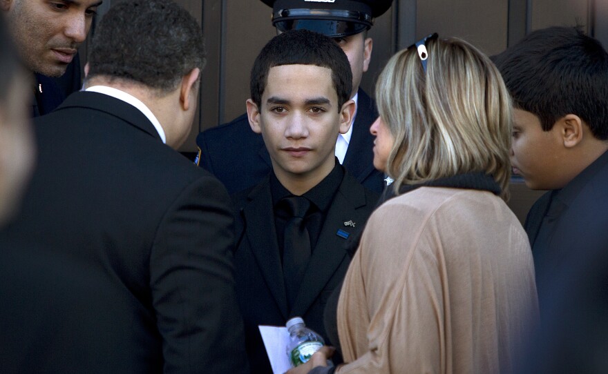 Jaden Ramos, son of slain NYPD officer Rafael Ramos, arrives for his father's wake at Christ Tabernacle Church in Queens, N.Y., on Friday.