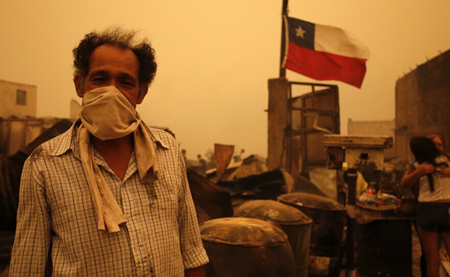 A man in Santa Olga, Chile, as the town was consumed by flames on Thursday.