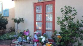 A memorial of flowers, candles and signs sits in front of the House of France in Balboa Park, Nov. 16, 2015.