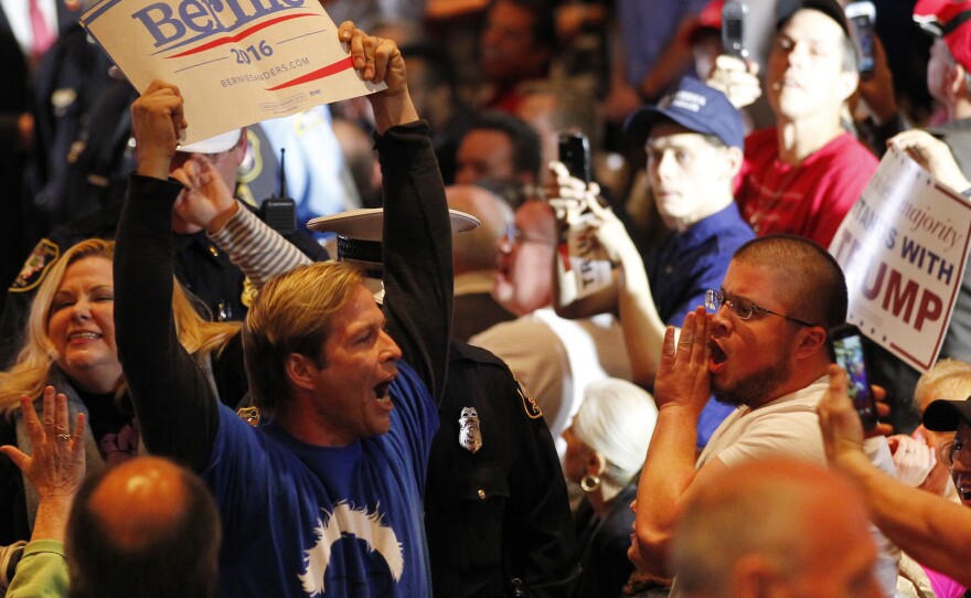 A Bernie Sanders supporter is taken out by police from a Donald Trump rally in Cincinnati on Sunday.