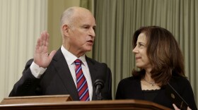 California Gov. Jerry Brown takes the oath of office as his wife, Anne Gust Brown, looks on during his inauguration at the state Capitol Monday in Sacramento, Calif., Jan. 5, 2015.