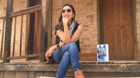 Author Sarina Dahlan is pictured with her book, "Reset" in an undated photo. "Reset" was published May 25, 2021.