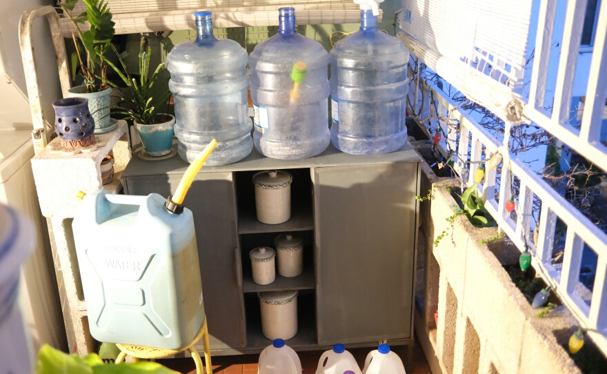 Water jugs litter the patio of a third-floor apartment, which is too high for water to reach even on days when the first floor gets just a trickle because of low pressure.