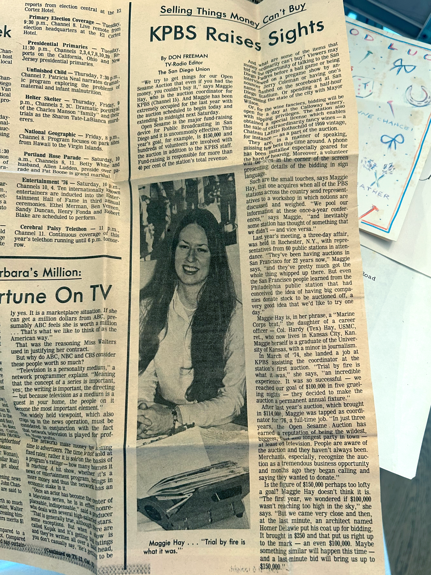 A newspaper clipping featuring Maggie, Chelsea Coleman's mother, discussing her work with KPBS auctions.